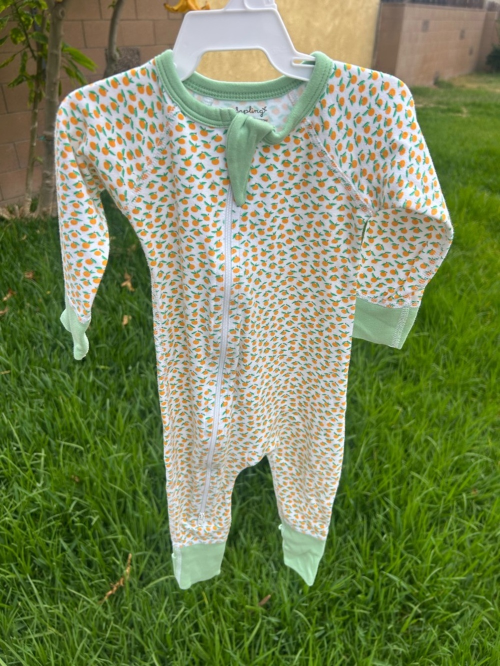 Kids One-Piece Footie in White with Orange Print and Light Green Trim